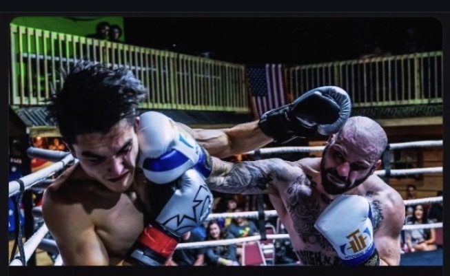 Fight Judge AI founder landing a punch during a live boxing match.